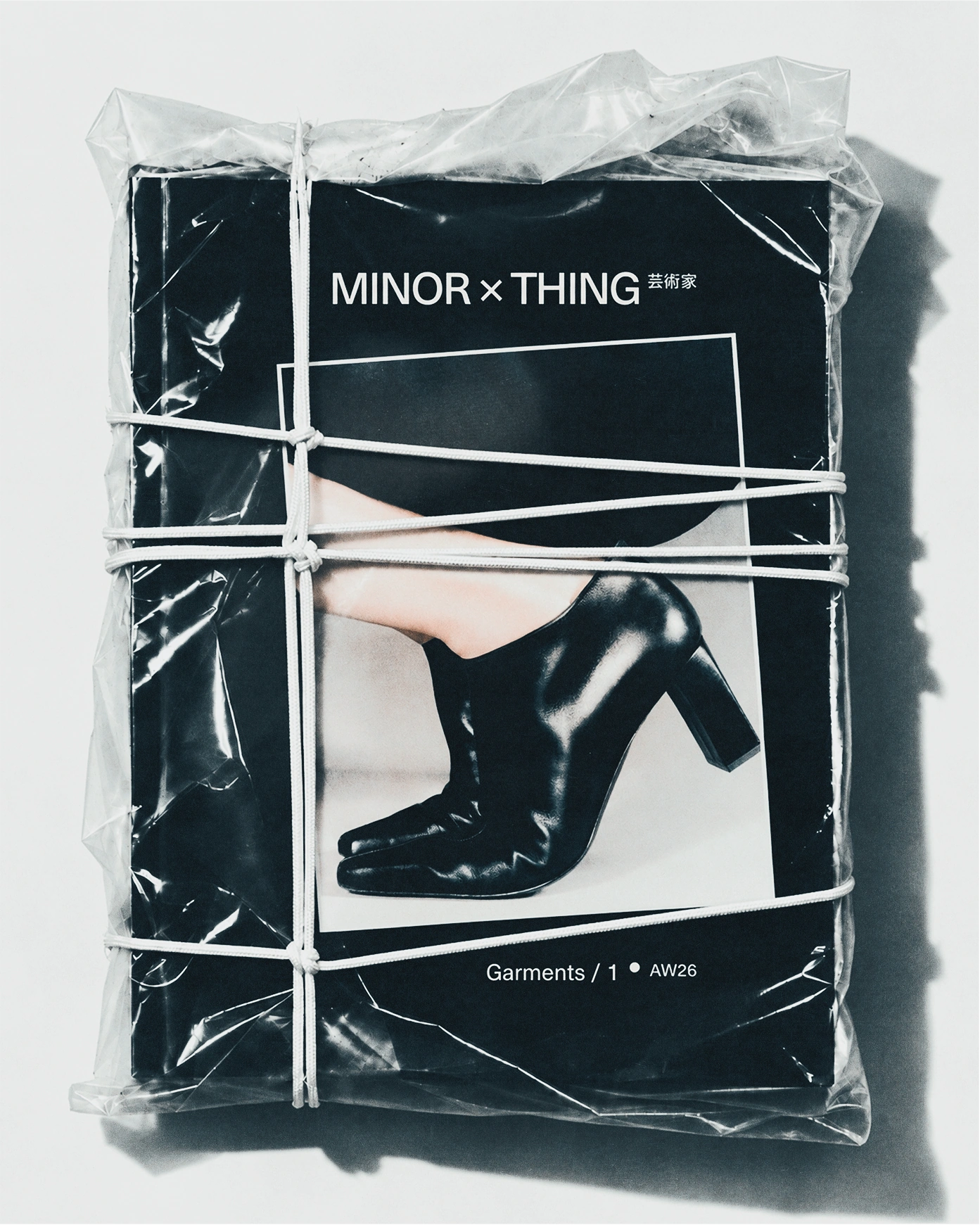Minor Thing publication wrapped in translucent plastic and tied with white string.