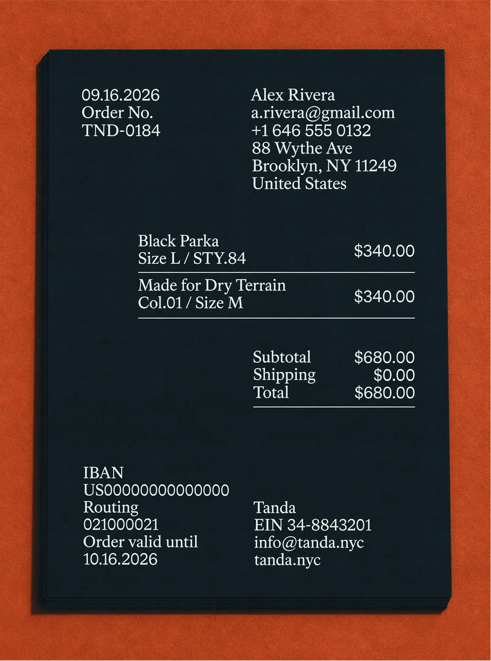 Black Tanda receipt with white itemized purchase details on an orange surface.