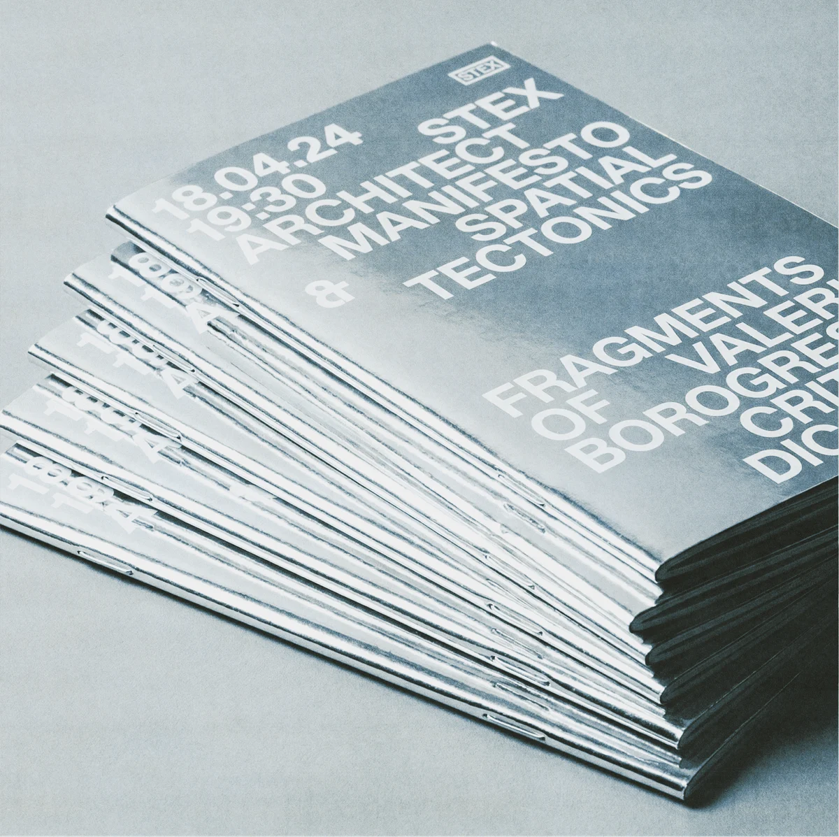 Stack of gray architectural event flyers with large white typography.